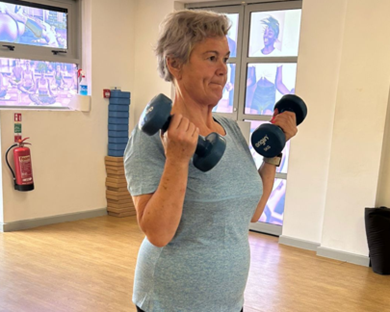 Carolyn Harris MP lifting two dumbbells