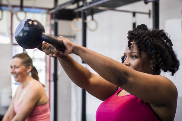 Athlete exercising with kettlebell in the gym.