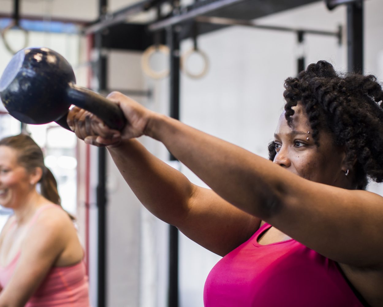Athlete exercising with kettlebell in the gym.
