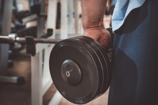 Muscular man during workout in the gym