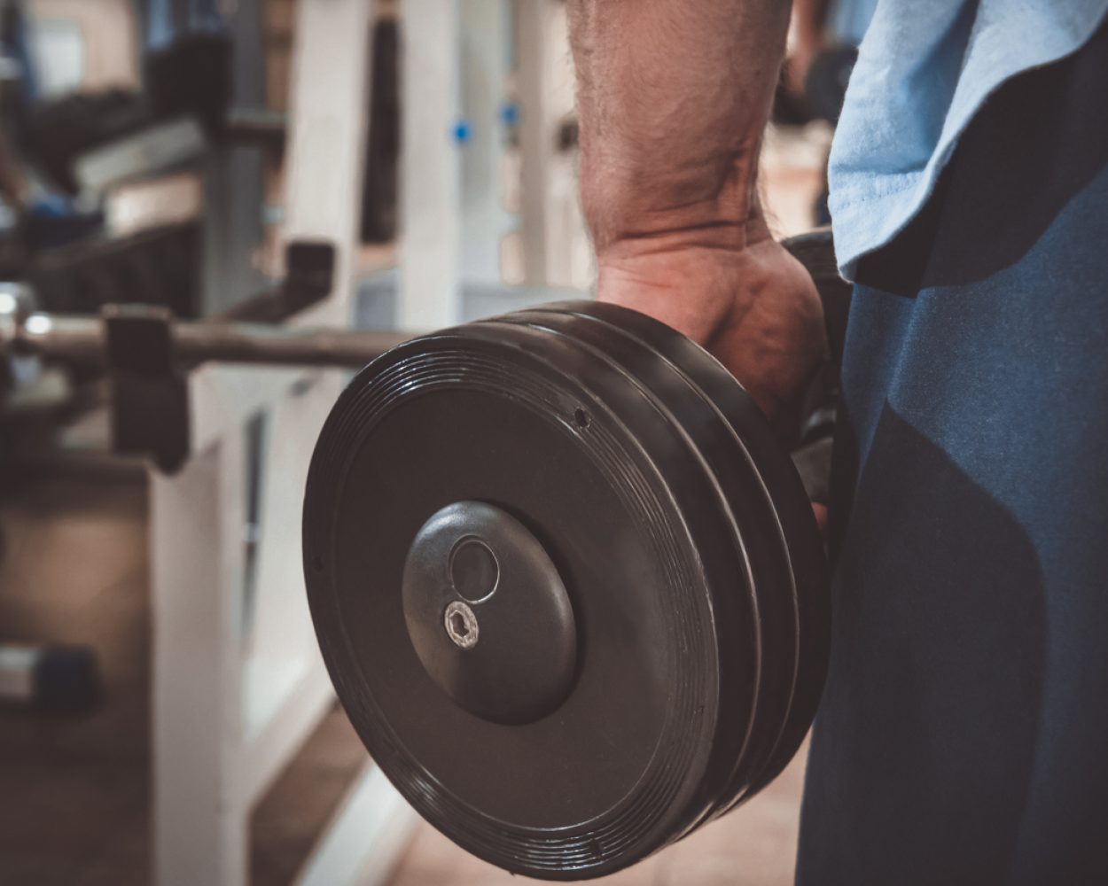 Muscular man during workout in the gym