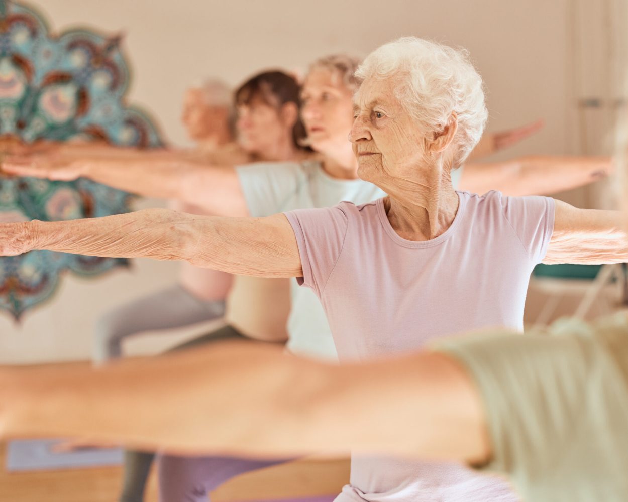 An older woman joins friends in a group exercise class.