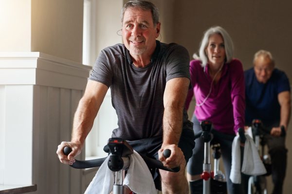 Shot of a group of seniors having a exercising class at the gym
